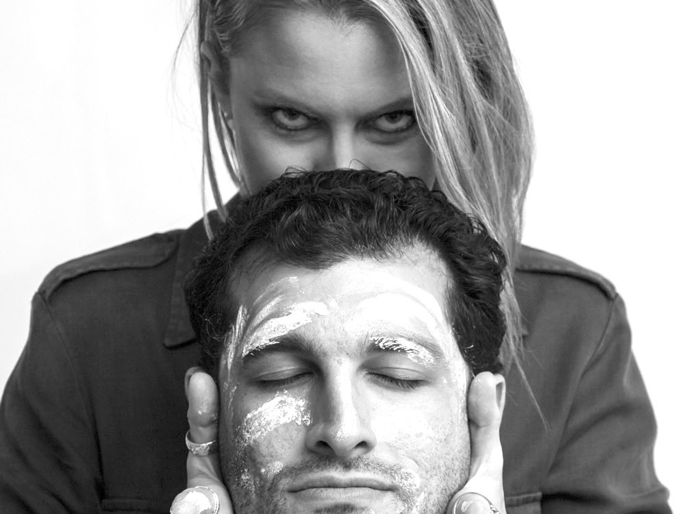 Boss Lady Stace holding a client's face during a sanctuary session — black and white portrait